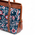 Canvas Tote Bag - Floral patterned bag with brown leather handles and trim on a white background