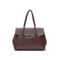 A dark brown leather handbag with a structured rectangular shape, double top handles, and a front flap, shown against a plain white background. Bag by HBH